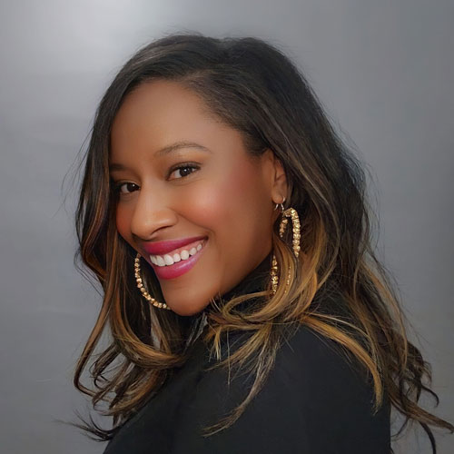 Headshot of Reecie Colbert smiling to camera