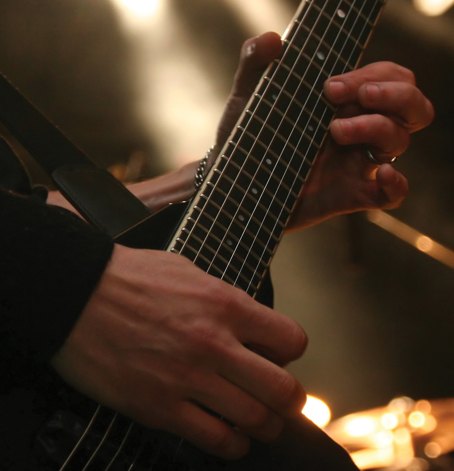 Hands playing on a guitar