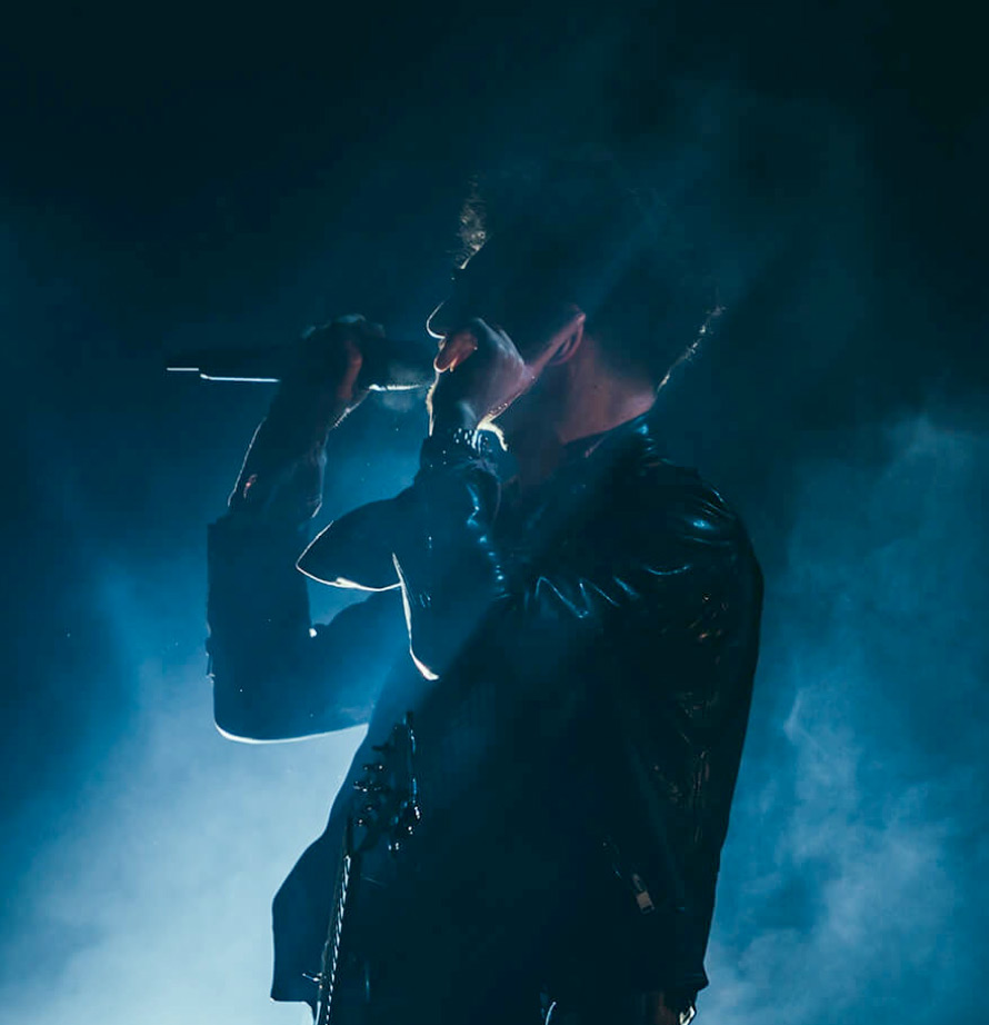 Singer surrounded by blue smoke