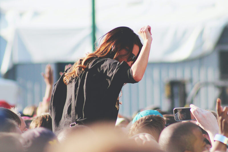 Person on shoulders in concert crowd