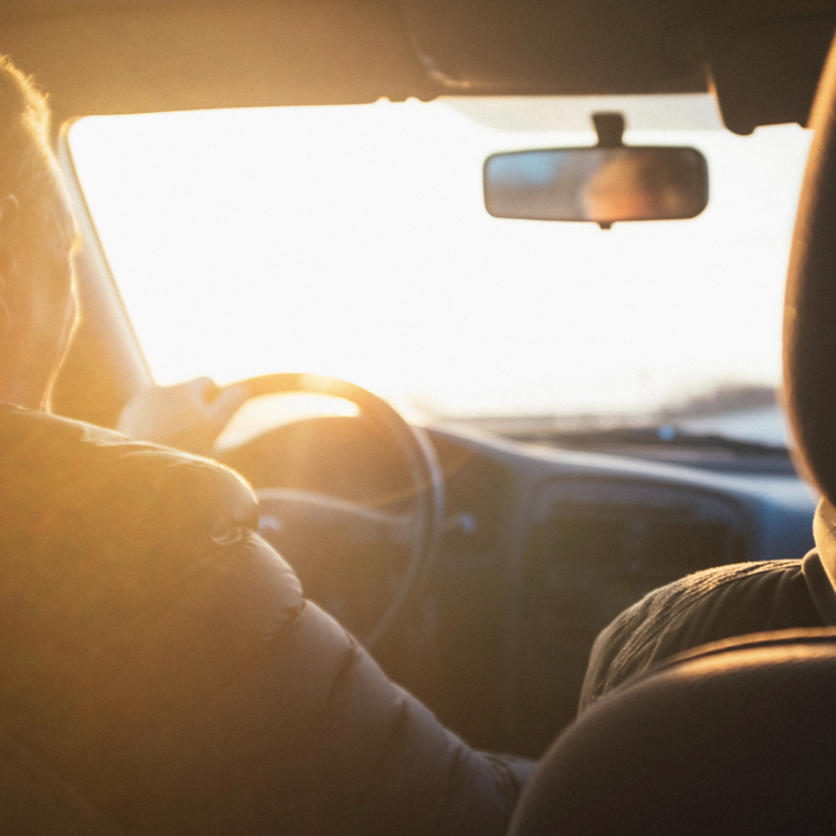 Someone driving with golden sunshine pouring into the car