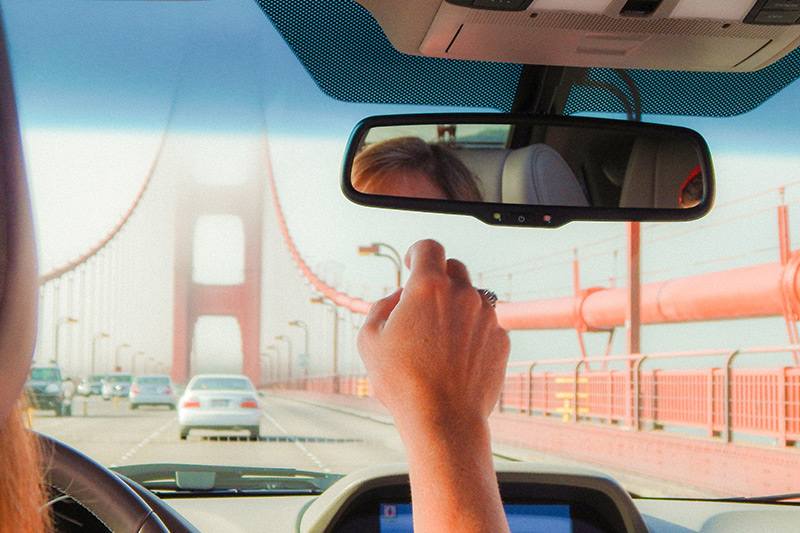 Woman driving over Golden Gate Bridge