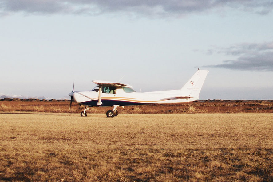 Small plane in a field of brown grass