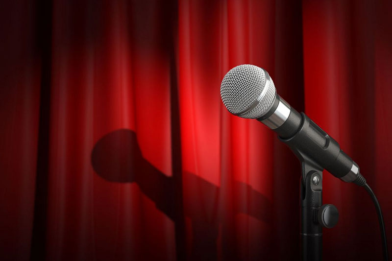 Microphone against a red curtain