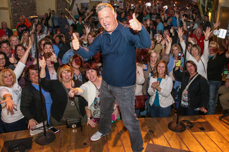 Image of Buzz Brainard with a crowd at the Music Row Happy Hour