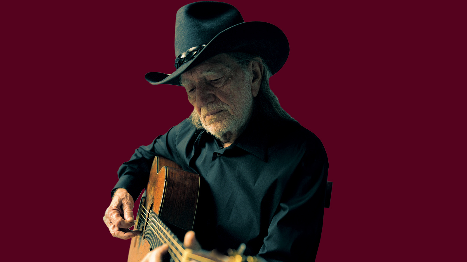 Willie Nelson playing guitar