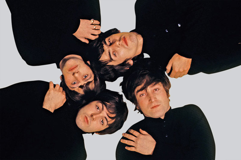 Overhead shot of The Beatles on a grey background